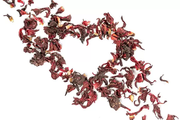 Heart made from dry red flower petals, the concept of love for tea