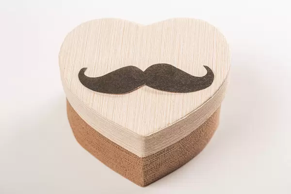 Heart shaped gift box with mustache - happy father's day or birthday greeting concept
