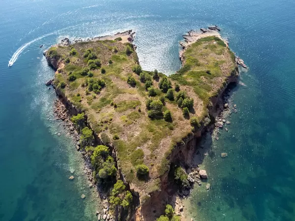 Heart-shaped headland formed by the reddish cliffs at Kokkinokastro beach, Alonnisos. Drone photography