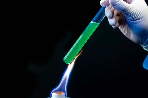 Heating the reagent over a fire on a black background (Flip 2020)