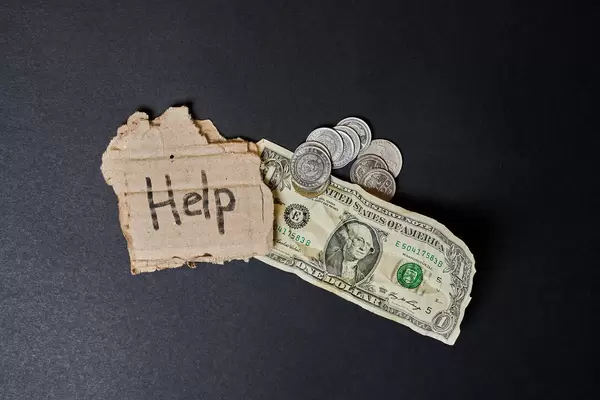 Help text on a piece of paper with coins and money