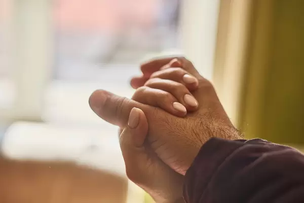 Helping hands. Close-up view of two unrecognizable people holding hands in comfort (Flip 2020)