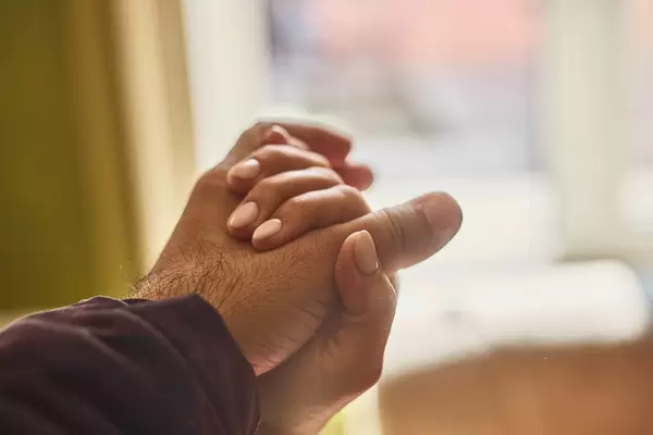 Helping hands. Close-up view of two unrecognizable people holding hands in comfort