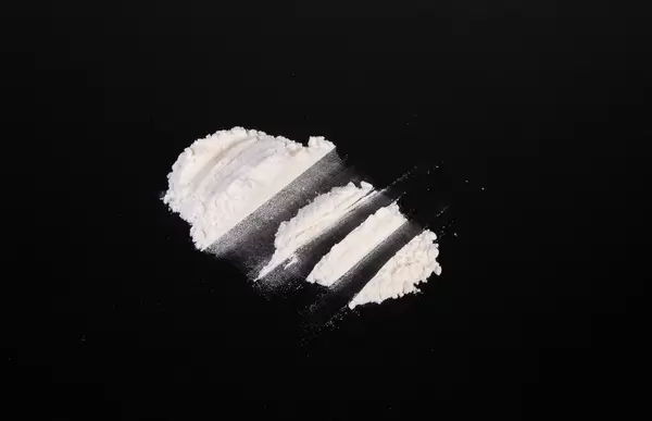 Heroin divided into paths on a black background