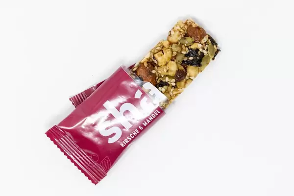 High Angle Shot - Share Foods - Organic Nutbar with Cherries and Almonds on white Background