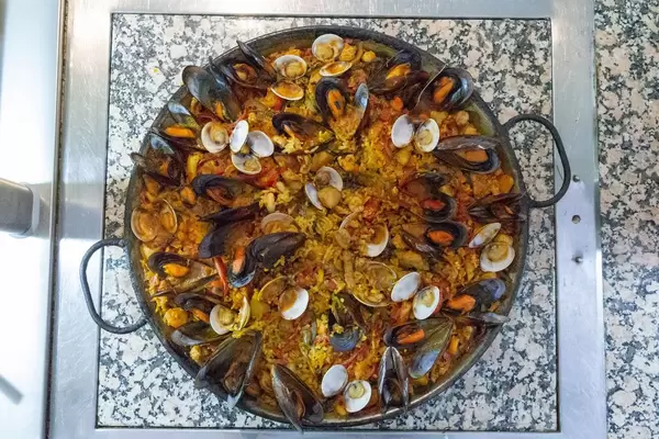 High angle view of paella with fresh mussels in a cast iron pan