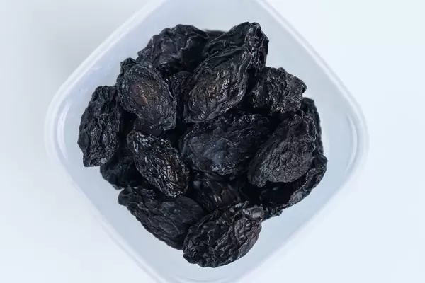 High Angle View of the Dry Plums in the Plastic Container