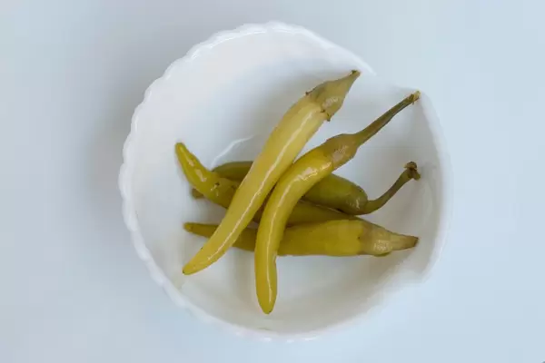 High Angle View of the Green Chilly Peppers in White Bowl