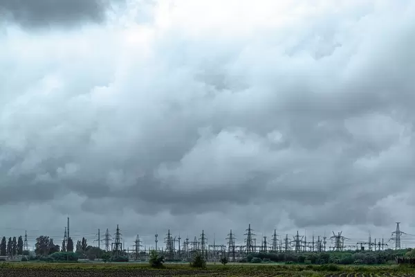 High-voltage power lines with sky background. Electricity distribution station