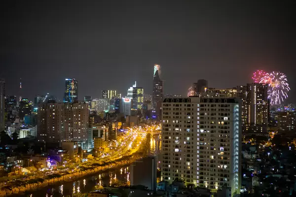 Ho Chi Minh City Night Photo with Bitexco Financial Tower and 2021 New Year Fireworks at Landmark 81 and Saigon River