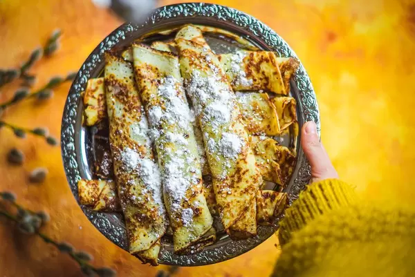 Holding Frying Pancakes With Chocolate Filling On Orange Background Close Up (Flip 2020)