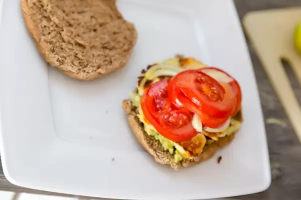Home made halloumi-cheese burger with avocado and tomato