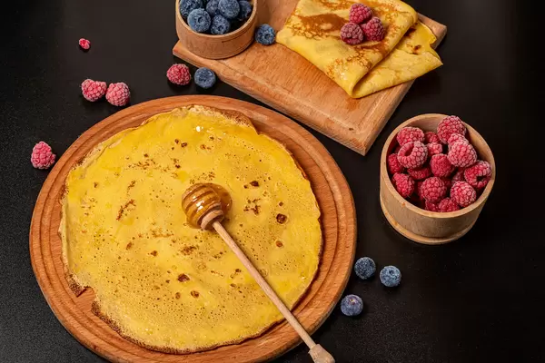 Homemade breakfast, pancakes with berry and honey