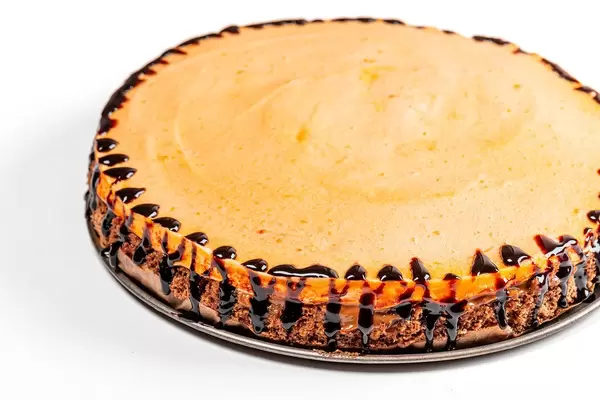 Homemade cake with chocolate biscuit, condensed milk and orange souffle