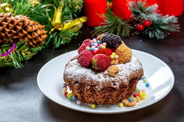 Homemade Christmas cupcake with strawberries, raspberries and mulberries