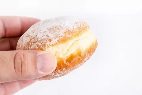 Homemade Donuts with powdered sugar in the hand