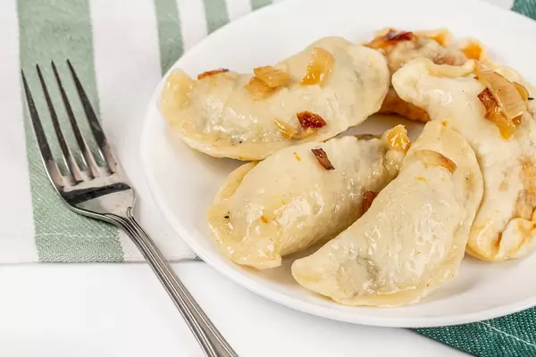 Homemade dumplings served with fried onions