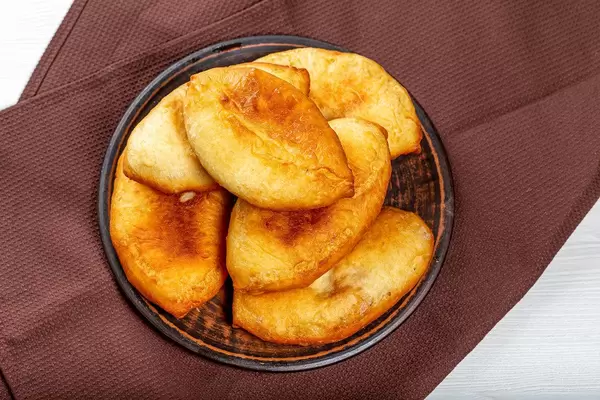 Homemade fried pies on a plate. Top view
