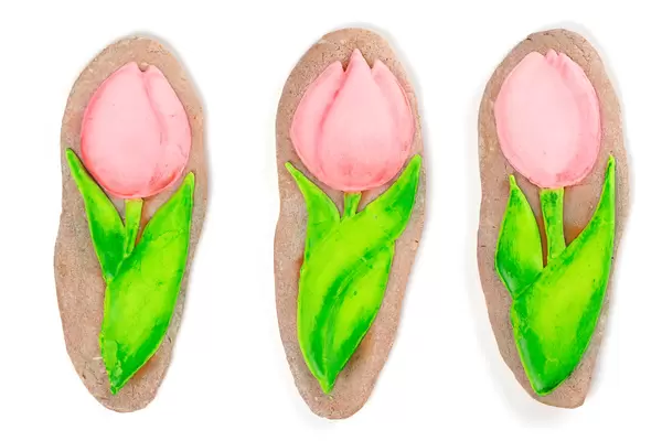 Homemade gingerbreads in the form of tulip on white background, international women's day concept