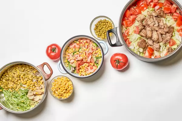 Homemade organic salads on white table