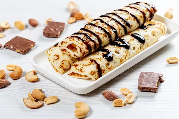 Homemade pancakes with chocolate topping and nuts (Flip 2019)
