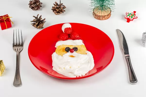 Homemade santa pancake breakfast for kids on red plate