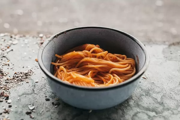 Homemade spaghetti in a vintage plate. Outdoor dinner