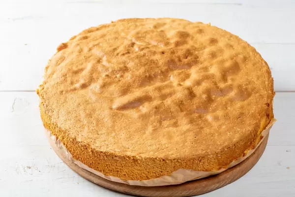 Homemade sponge cake on a white wooden table