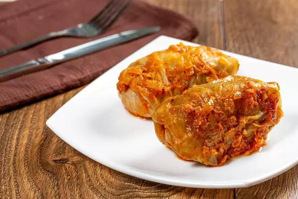Homemade stuffed stewed in tomato sauce with knife and fork (Flip 2019)