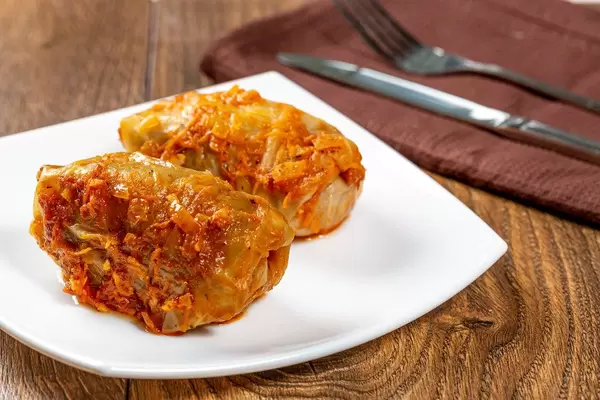 Homemade stuffed stewed in tomato sauce with knife and fork