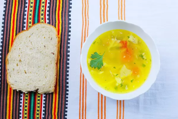Homemade tripe soup served with white bread (Flip 2019)