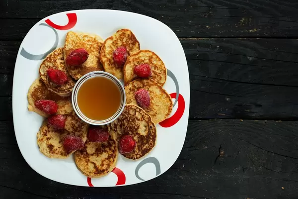 Honey-Oat Pancakes with frozen strawberry fruits