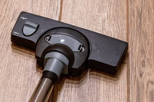 Hoovering floor with vacuum cleaner