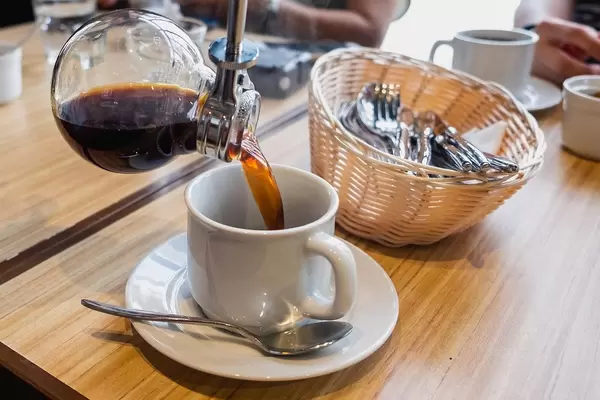 Hot coffee being poured in to mug, close up shot (Flip 2019)