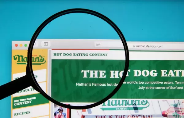 Hot Dog Eating Contest text on a computer screen with a magnifying glass