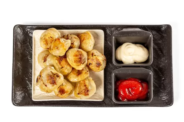 Hot fried dumplings with sauces, top view