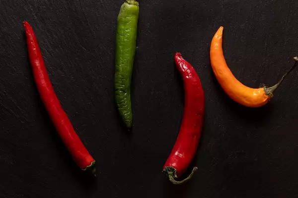 Hot Paprika above black background concept