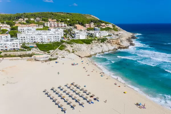 Hotels and tourist apartments directly at the beach of Cala Mesquida, Mallorca. Aerial view