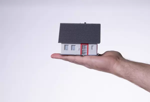 House in hand isolated on white