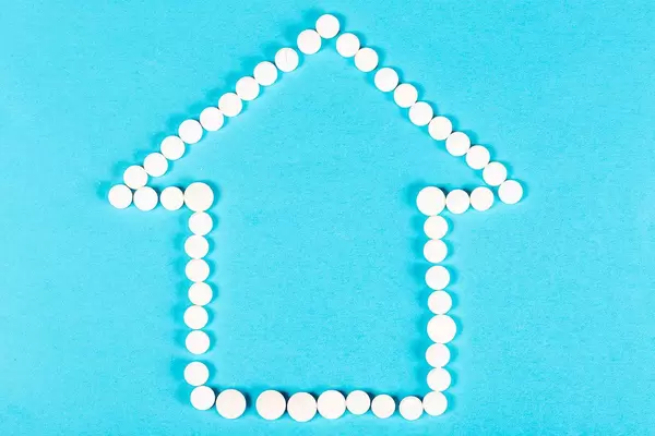 House of white pills on a blue background