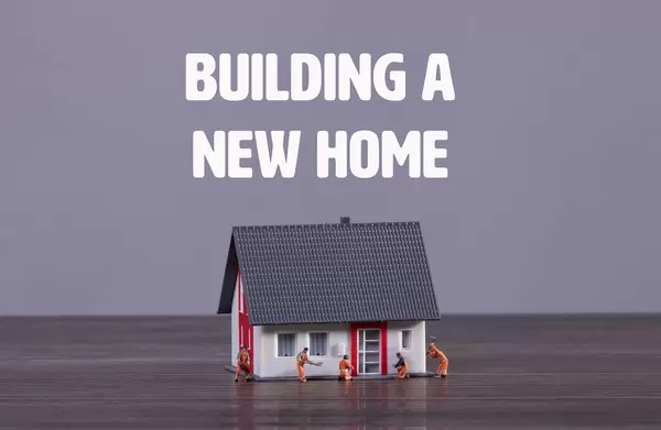 House with miniature workers and Building a New Home text