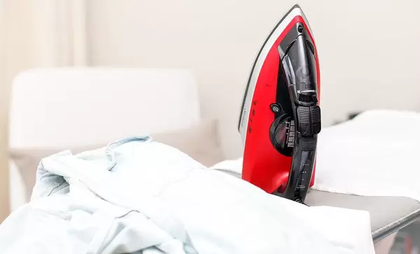 Housework; iron on an ironing board