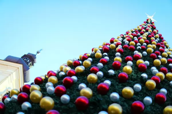 Huge Christmas tree with star on top, blue sky background (Flip 2019)