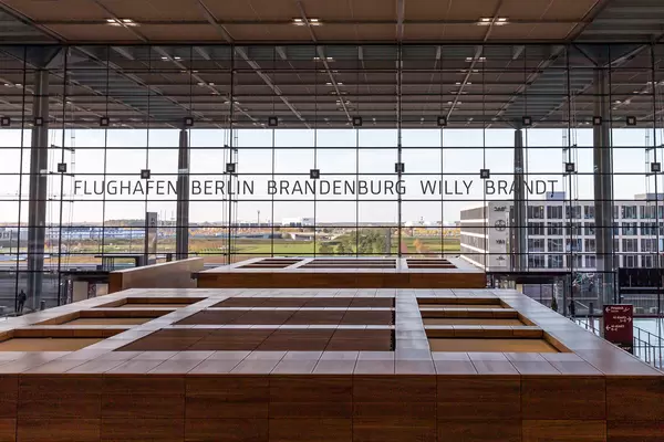 Huge glass windows and wooden check-in area of the new Berlin airport "Brandenburg Willy Brandt"