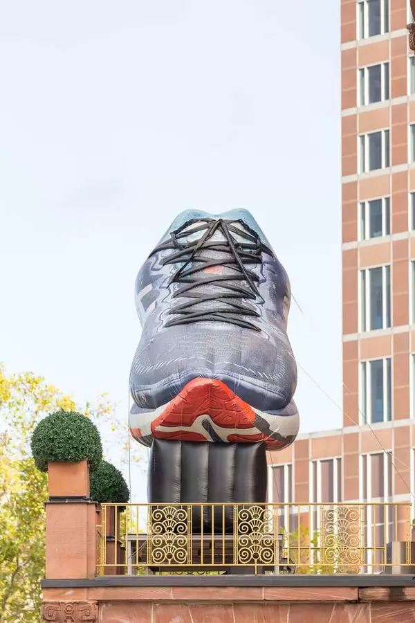 Huge, inflatable running shoe on the balcony