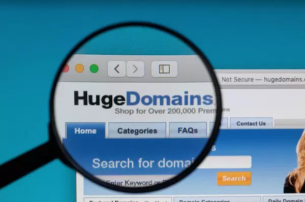 HugeDomains logo under magnifying glass