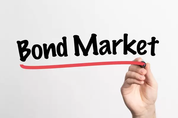 Human hand writing Bond Market on whiteboard