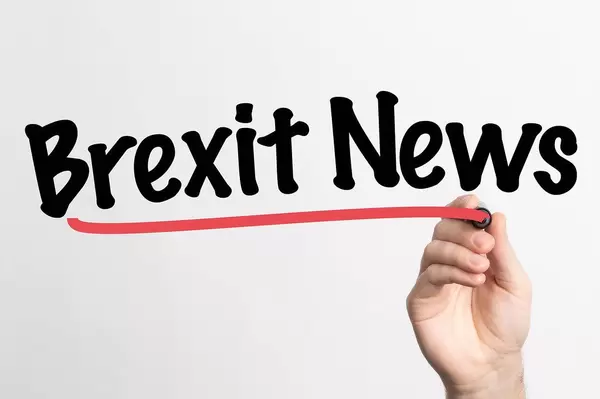 Human hand writing Brexit News on whiteboard