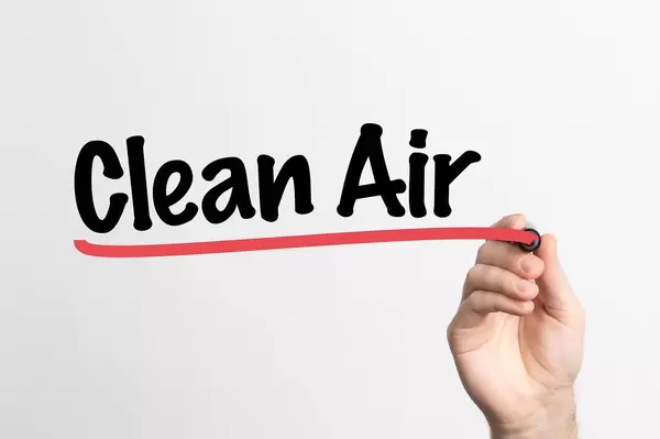 Human hand writing Clean Air on whiteboard
