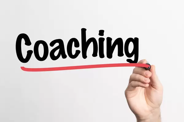 Human hand writing Coaching on whiteboard